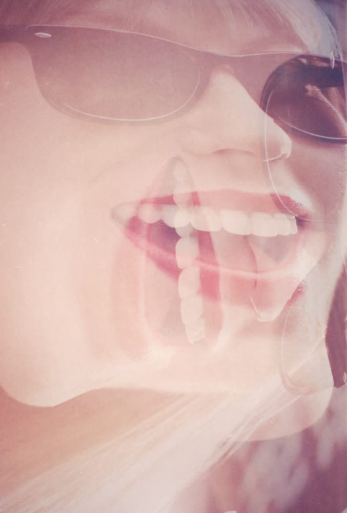 Multiple exposure of a female face wearing sun glasses